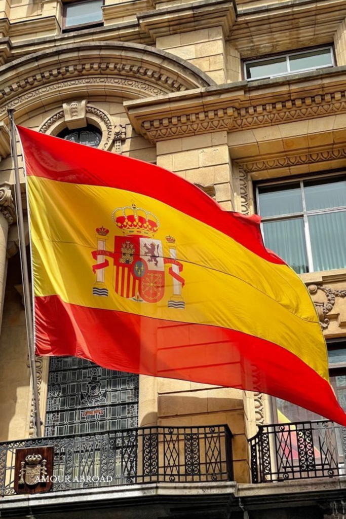 a Spanish flag waving over a building 