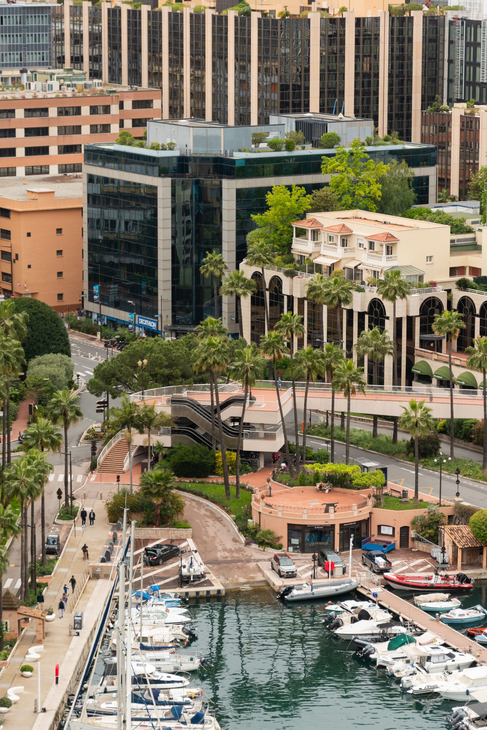 Aerial view of Monaco-Ville's luxury marina and urban landscape featuring yachts and modern architecture.