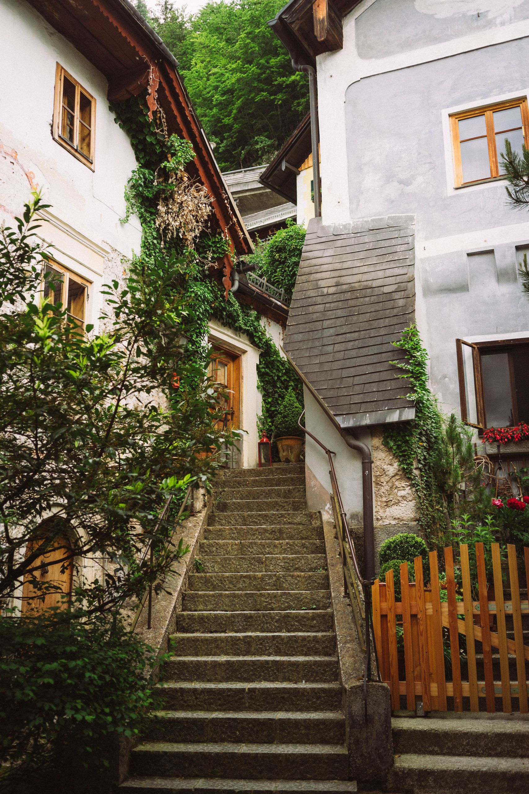 Picturesque narrow stairs and traditional houses in Hallstatt, Austria.