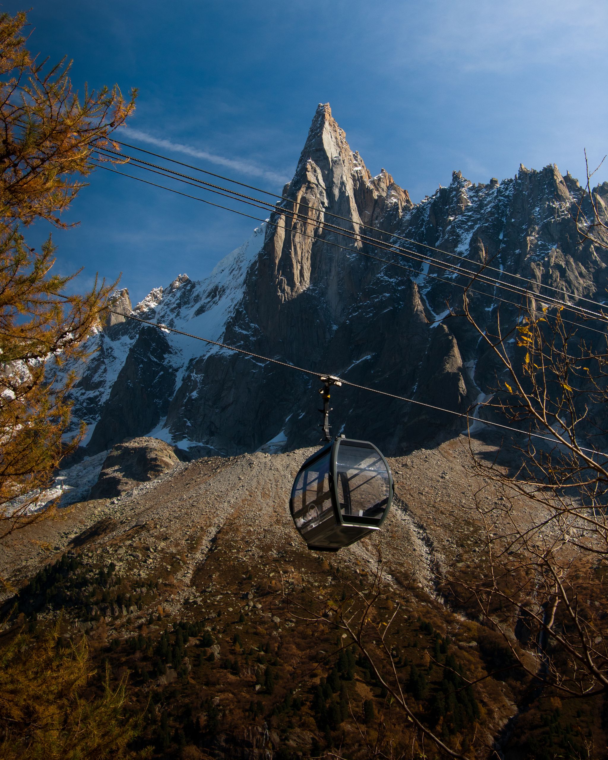 Spectacular view of cable car and rocky peak in Chamonix-Mont-Blanc, France, during autumn sunset.