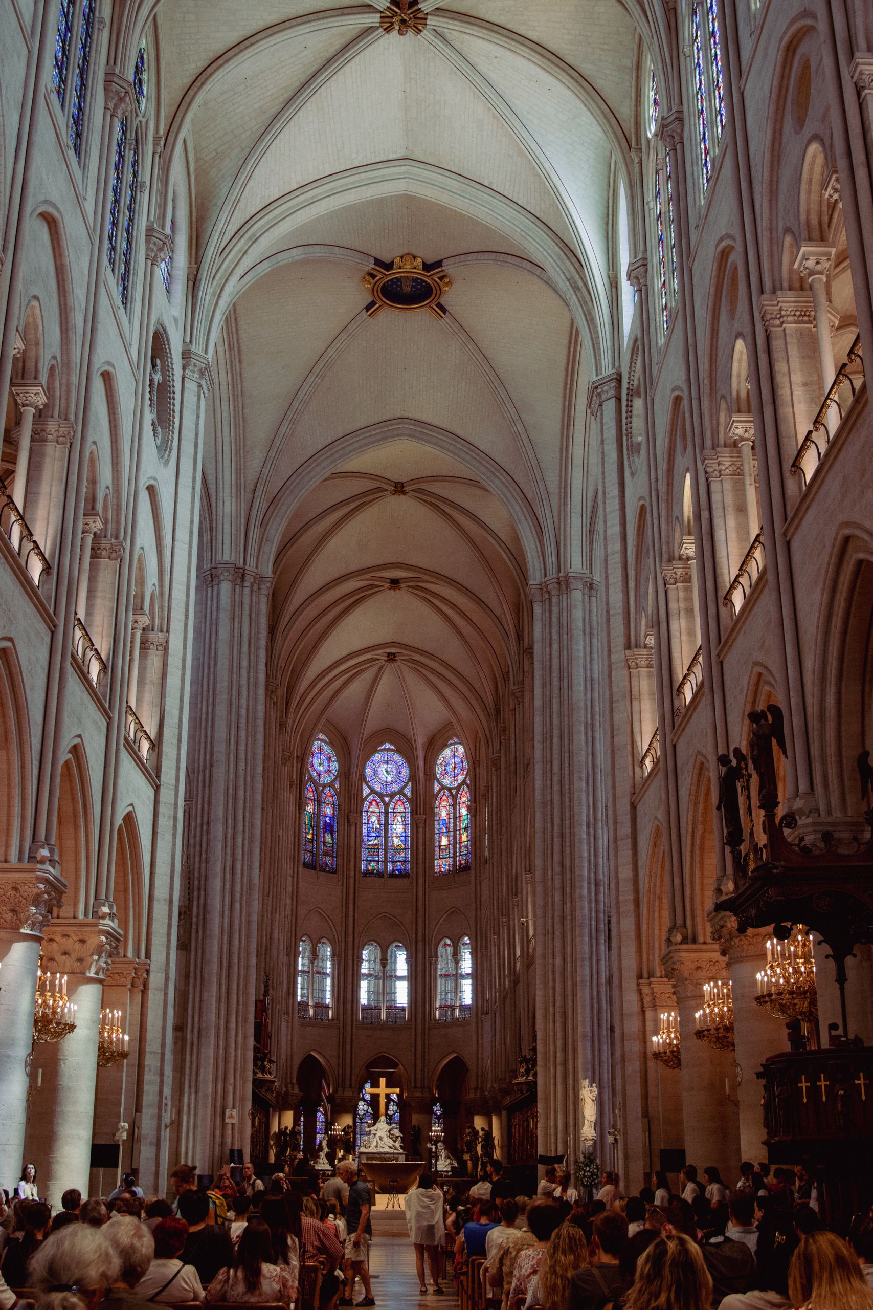 The majestic interior of Notre-Dame Cathedral in Paris, showcasing its Gothic architecture and stained glass windows.