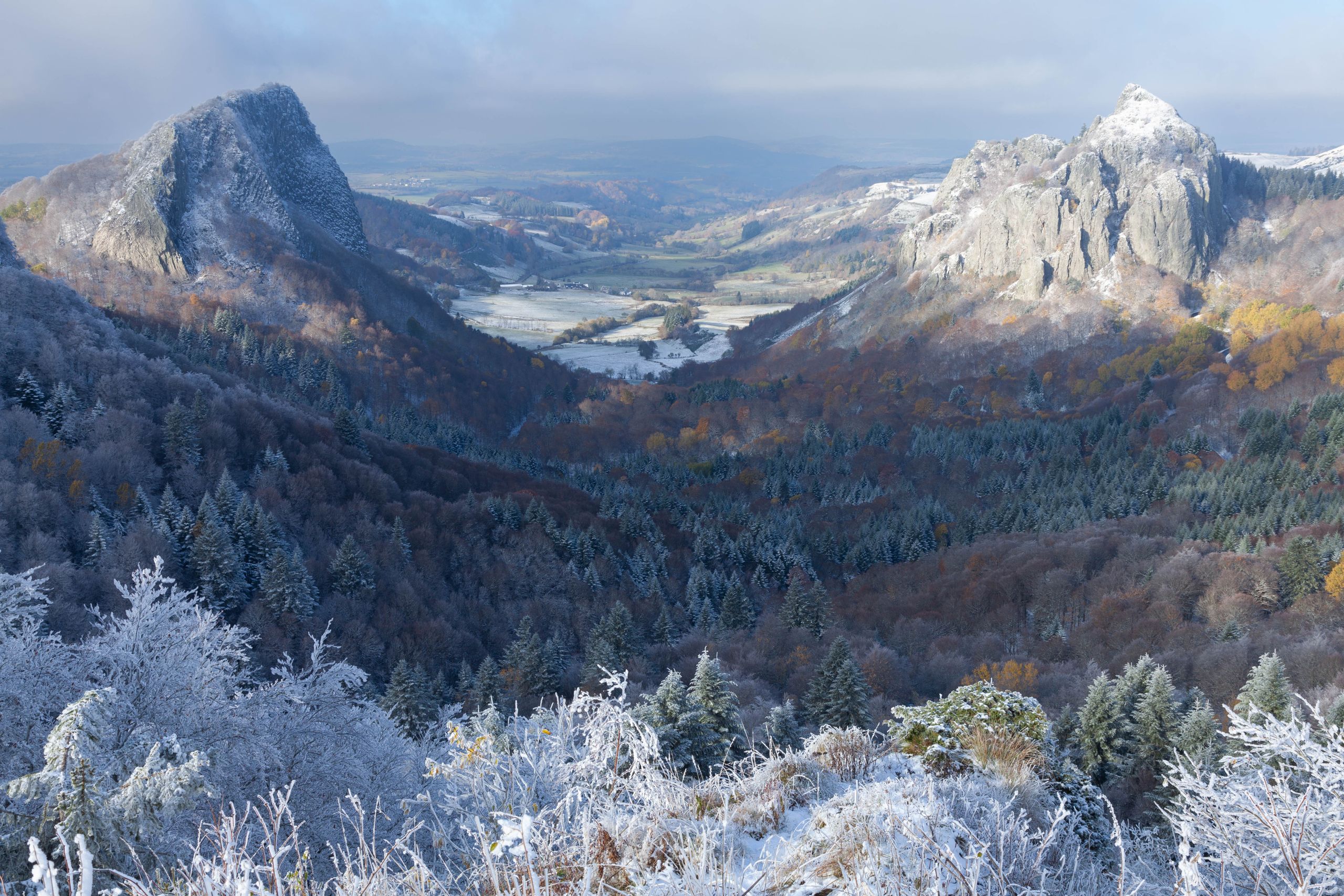 Stunning winter view of Le Mont-Dore's snowy peaks and valleys in Auvergne, France.